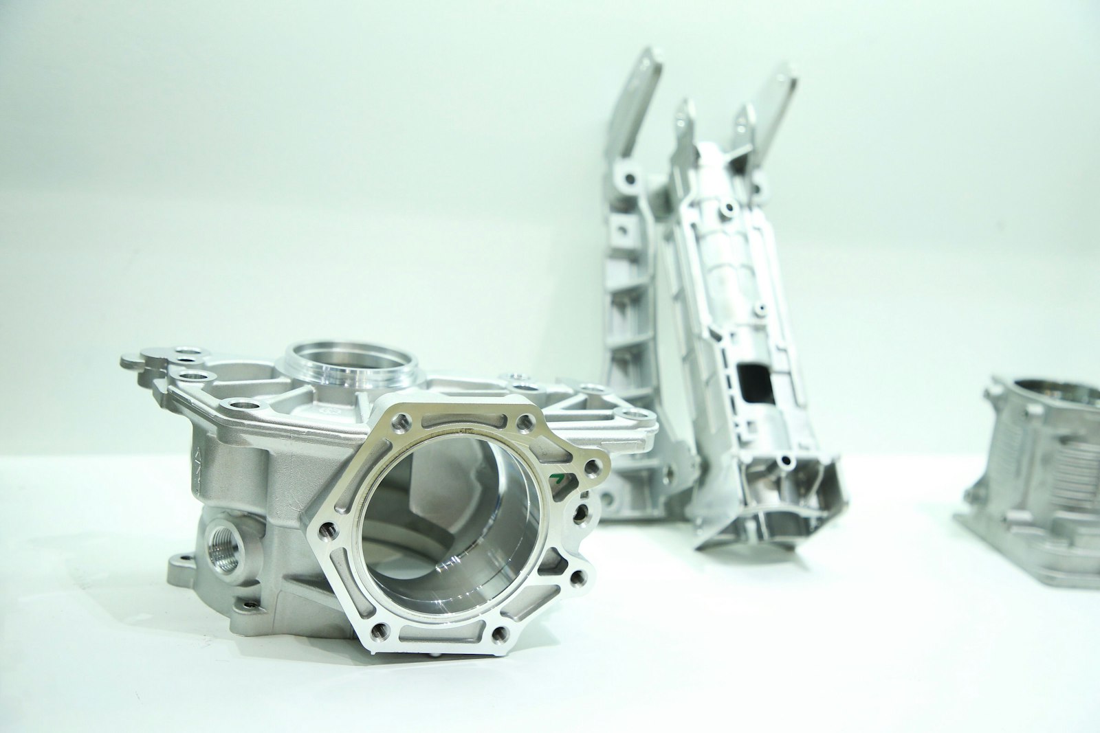 Machined aluminium components on a white workbench