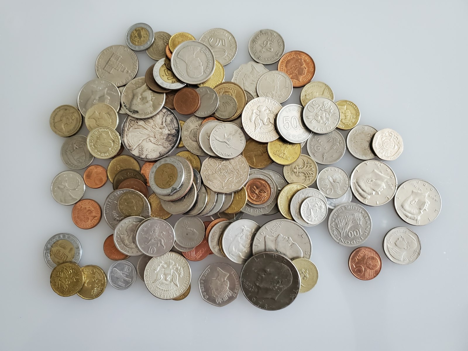 Pile of mixed gold and silver coins from different countries