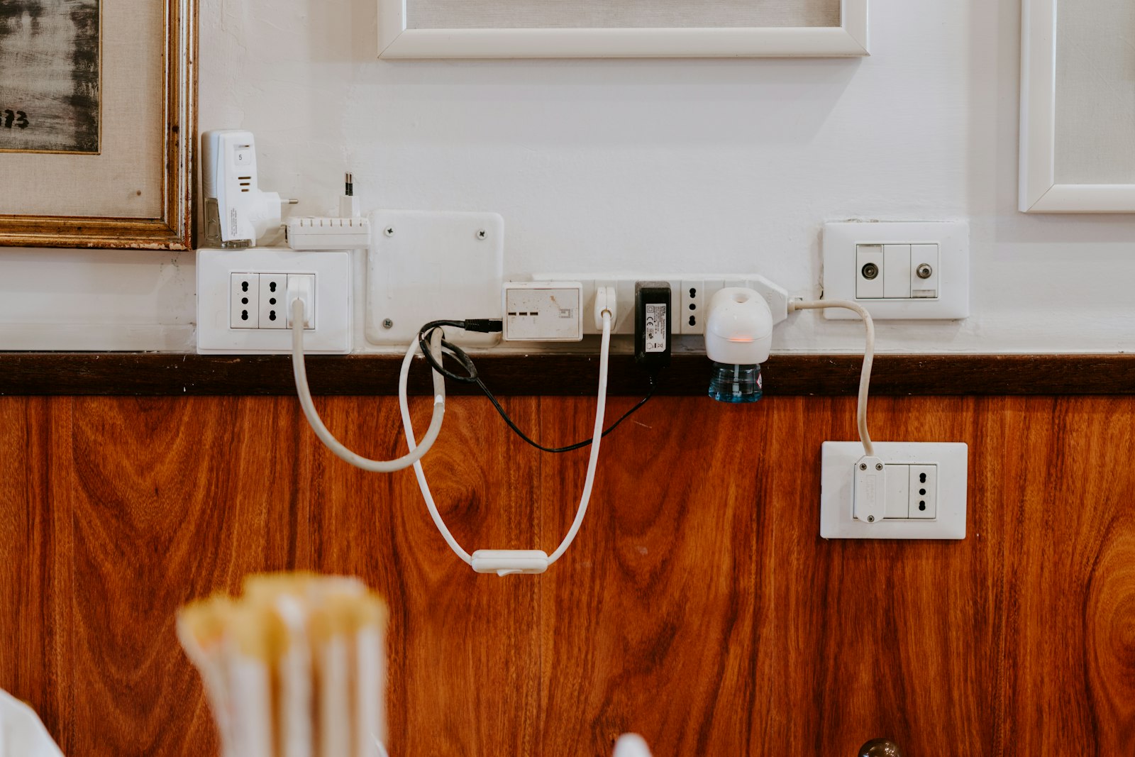 Wall sockets crowded with adapters and plugged-in cables